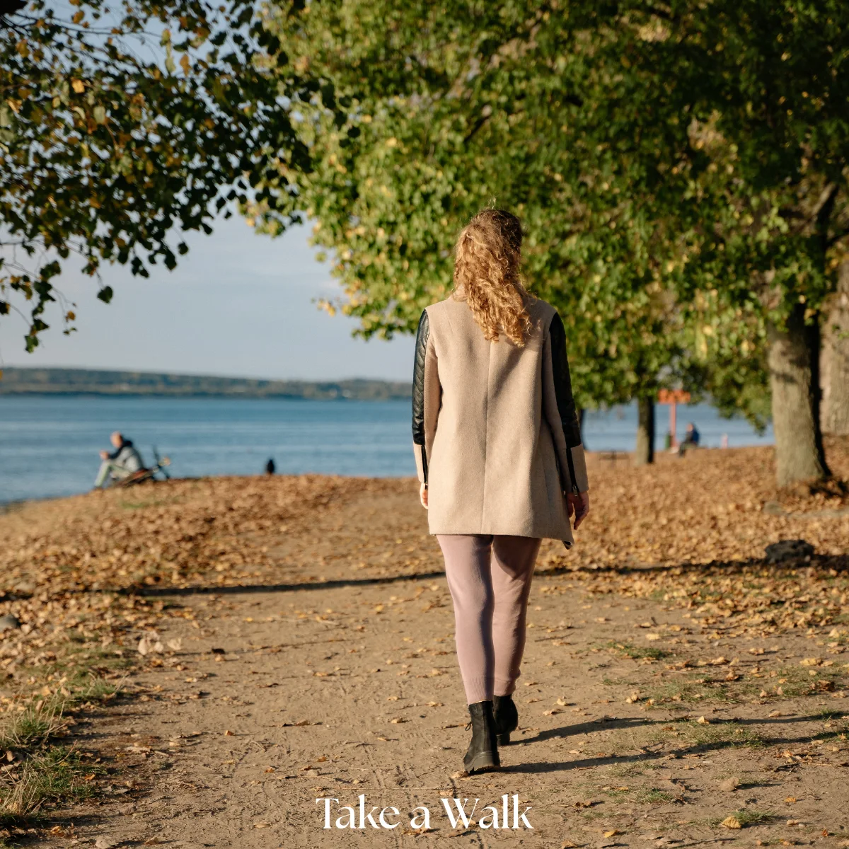 Woman walking on a peaceful path with water view